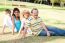 Young Family Relaxing In Park