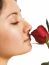 A Girl Smelling A Rose