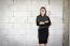 Businesswoman Standing Holding A File  In A Brick Building