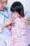 Doctor Helps Little Asian Girl Taking Respiratory, Inhalation Therapy