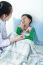 Asian Boy Having Respiratory Illness Helped By Health Professional In Hospital