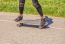 Young Woman Skateboarding In The Park