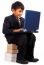 Boy Sitting On A Pile Of Books