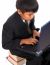 Boy Sitting On A Pile Of Books