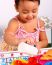 Kid Playing At Pouring Cup Of Tea