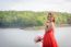 Beautiful Woman Wear Red Evening Dress Hold A Bouquet Of Flowers