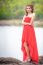 Beautiful Woman Wear Red Evening Dress Over Mountains And Rivers