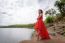 Beautiful Woman Wear Red Evening Dress Over Mountains And Rivers