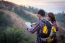 Tourists Look At A Map On The Tablet On Mountain