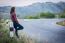 Tourist Hitchhiking Woman Standing On The Road In The Mountains