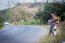 Tourists Man Walk Along Mountain Roads