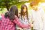 Group Of Asian Teenager Walking In The Park And Enjoyed Watching Video From Smartphone