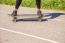 Young Woman Skateboarding In The Park