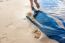 Footprints In The Wet Sand Of The Beach