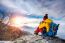 Young Woman Hiker Taking Photo With Smartphone On Mountains Peak In Winter