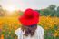 Woman Wearing A Red Hat In A Field Of Flowers