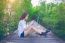 Girl Sitting Alone And Hand Holding Camera On A The Wooden Bridg