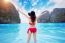 Young Woman In Red Bikini Sitting On The Beach