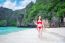 Young Woman In Red Bikini Sitting On The Beach