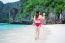 Young Woman In Red Bikini Sitting On The Beach