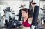 Young Fitness Woman Executed Exercise With Exercise-machine In Gym