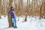 Young Beautiful Woman Walking Under A Snowfall