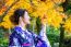 Asian Woman Wearing Japanese Traditional Kimono In Autumn Park. Japan