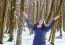 Portrait Of Young Beautiful Woman Playing With Snow In The Woods