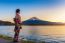 Asian Woman Wearing Japanese Traditional Kimono At Fuji Mountain. Sunset At Kawaguchiko Lake In Japan