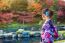 Asian Woman Wearing Japanese Traditional Kimono In Autumn Park. Japan