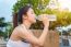 Sporty Young Woman Drinking Water After Jogging