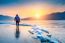 Professional Photographer With Camera On Frozen River In Winter