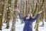 Portrait Of Young Beautiful Woman Playing With Snow In The Woods