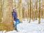 Young Beautiful Woman Walking Under A Snowfall