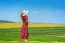 Woman Standing On Green Grass In Green Tea Field