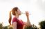 Sporty Woman Drinking Water On Sunlight