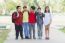 Group Of Kids Friends Arm Around Standing Having Fun And Smiling In Park