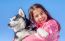 Happy Little Girl Holding Her Puppy Dog Husky