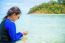 Asian Woman Look At The Clear Water In Their Hands On The Sea