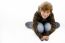 High Angle View Of Boy Sitting On Skateboard