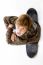 Top View Of Boy Sitting On Skateboard