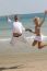 Young Couple Jumping At Beach