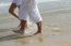 Male And Female Walking At Beach