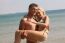 Man Holding Woman At Beach