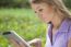 Woman Using Tablet Computer In Park