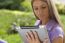 Woman With Tablet Computer In Park