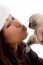 Young Woman kissing her Puppy