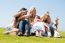 Happy Family Relaxing In Garden