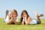 smiling sibling Lying In lawn