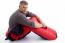 Man Sitting With Sleeping Bag